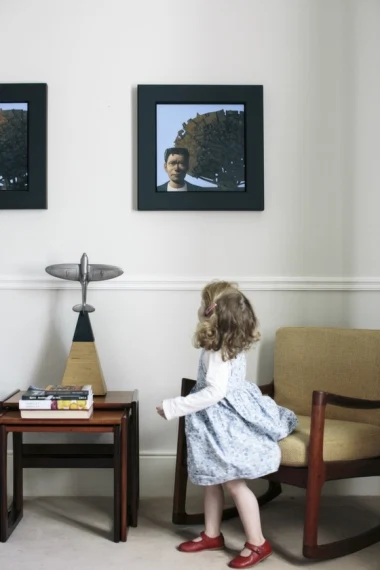 Alanna spins in front of a pair of John Boyd ?Arbor? paintings. The airplane sculpture by Andrew Clancy sits on a nest of G Plan tables. The mid-century rocker chair is by Ole Wanscher for France & Sons (Denmark, circa 1950).
