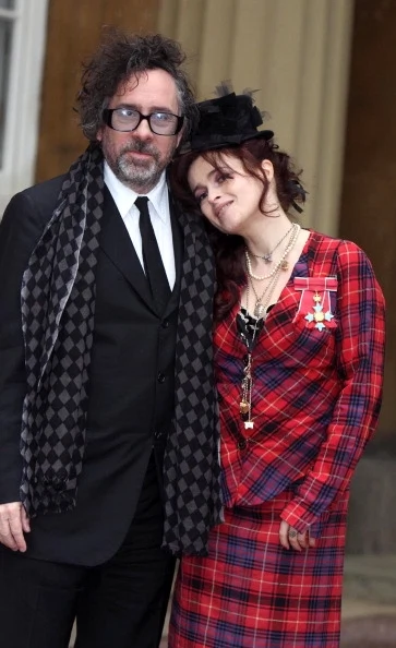 Helena Bonham Carter with her husband Tim Burton as she poses with her Commander of the British Empire (CBE) medal, after an Investiture ceremony at Buckingham Palace on February 22, 2012 in central London, England.