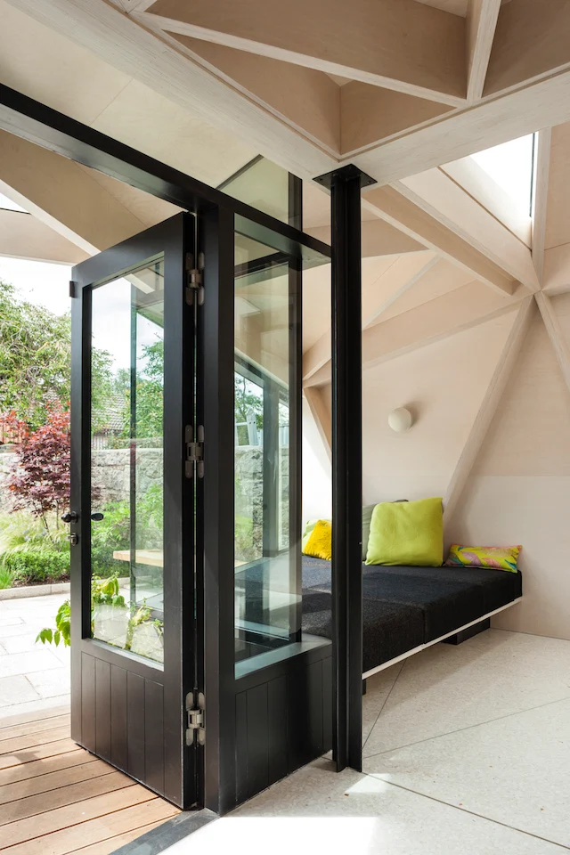 The layout allows the custom Oikos Furniture window seat and external covered areas to relate to the garden.