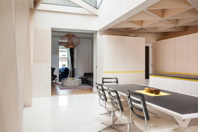 Plywood is used in three very different structural solutions within this project for its aesthetic, structural and economic properties. Reflective white Terrazzo floors reinforce the clean, modern look.