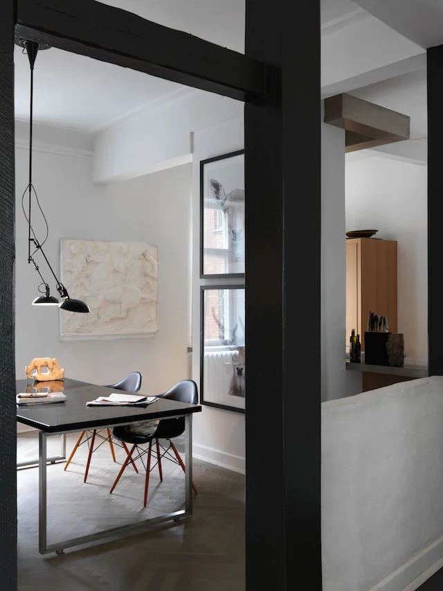 The plaster frieze, typical on the front of Scandinavian homes, makes a striking statement in the simple dining-room space, as does the black enamel pendant light, originally a floor lamp but adapted to hang over the table. 
