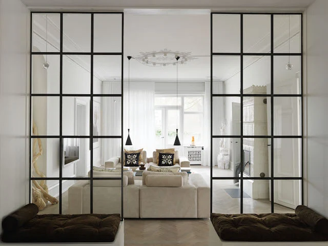 A big space on one floor, this Danish period apartment combines traditional architectural features with modern design. Inspired by lofts, Naja created a partition between the entrance and living room with dramatic panelled windows, painting the metal frames black.