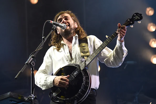 Winston Marshall performs on stage.