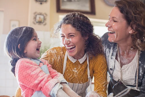Three generations of women playing in the kitchen