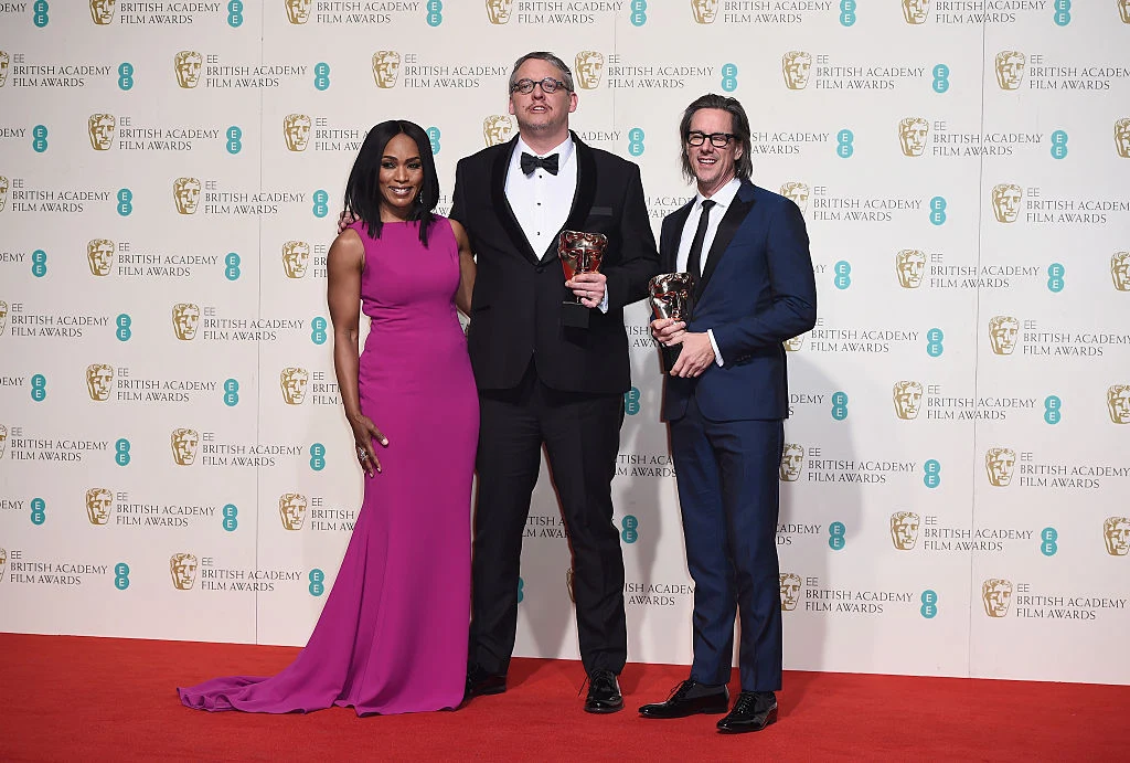 LONDON, ENGLAND - FEBRUARY 14: Angela Bassett poses with Best Adapted Screenplay winners Adam McKay and Charles Randolph in the winners room at the EE British Academy Film Awards at the Royal Opera House on February 14, 2016 in London, England. (Photo by Ian Gavan/Getty Images)