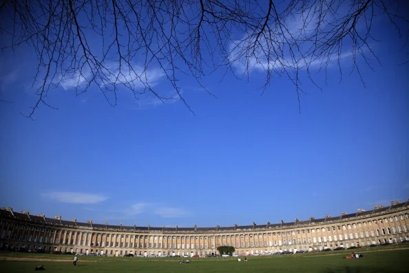 BATH, ENGLAND - MARCH 01: The sun illuminates the Royal Crescent in the heart of Georgian Bath on March 1, 2012 in Bath, England. One of the most popular tourist destinations in the westcountry, the city famed for its natural spa is hoping to gain from an influx of tourists thanks to the London 2012 Olympic Games. (Photo by Matt Cardy/Getty Images)