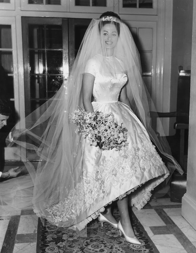 13th December 1960: Actress and author Jackie Collins celebrates her marriage to businessman Austin Wallace at Grosvenor House in London after a registry office ceremony. Her white satin wedding dress with intricate beading cost €400. (Photo by Central Press/Getty Images)