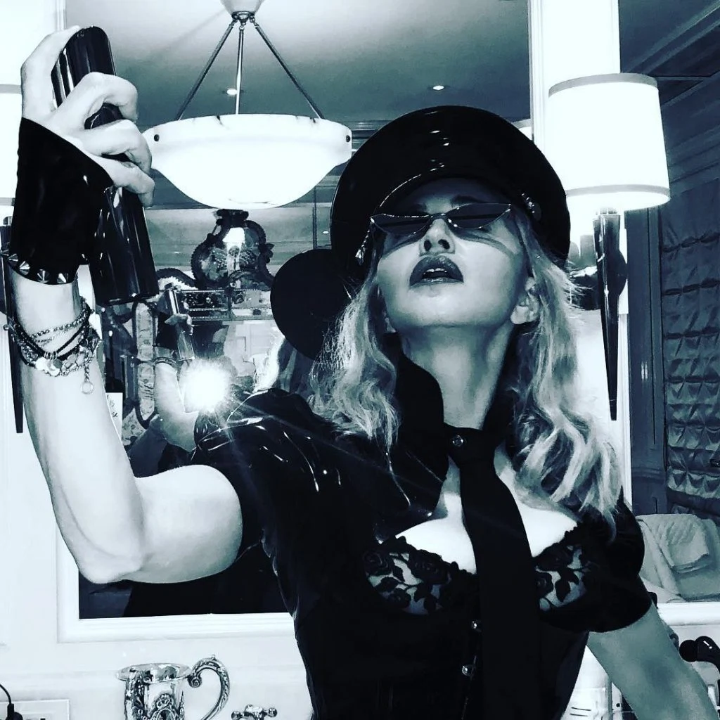 Madonna wears fingerless gloves