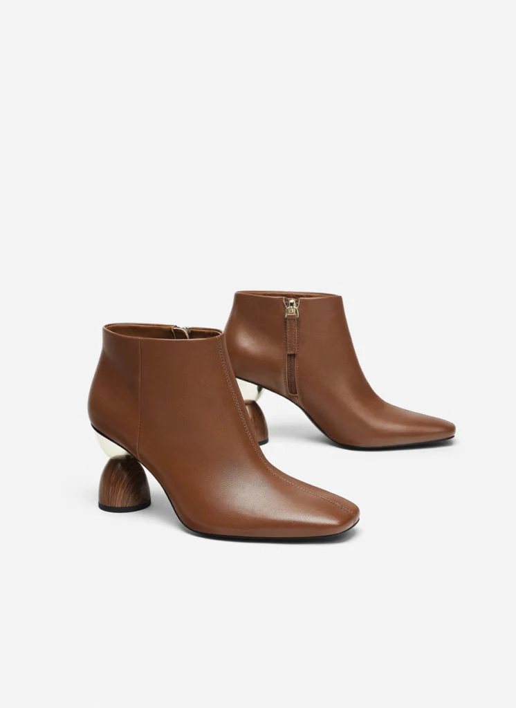 Leather ankle boots with asymmetric heels, €150 at uterque.com