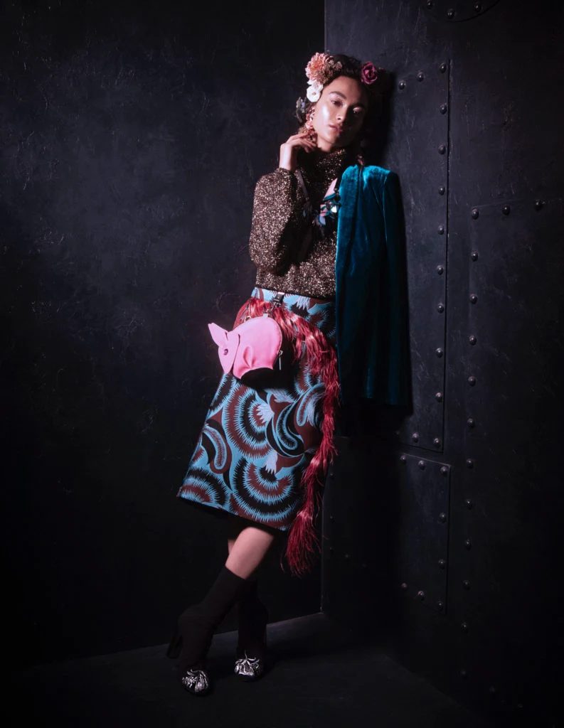 Metallic polo by Osman, €225 at Samui, blue velvet jacket by Galvan London, €1,025 at Havana, sequin necklace, €70; pink rabbit bag, €50; both Joanne Hynes at Dunnes Stores. Sock boots by Alexander McQueen, Brown Thomas, earrings by Mignonne Gavigan, €319 at Loulerie