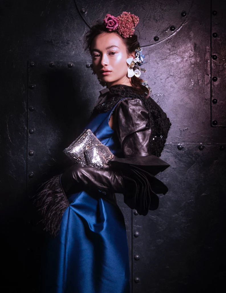 Feather trim dress by Caroline Kilkenny, €324 at Arnotts, limited edition Lola accordion sleeve shoulder length glove, €2,800 at Paula Rowan, embellished hood by conscious collection, €79.99 at H&M, white floral earrings by Petusa, €185, silver conscious clutch by Paula Ka, €269; both at Emporium Kalu.