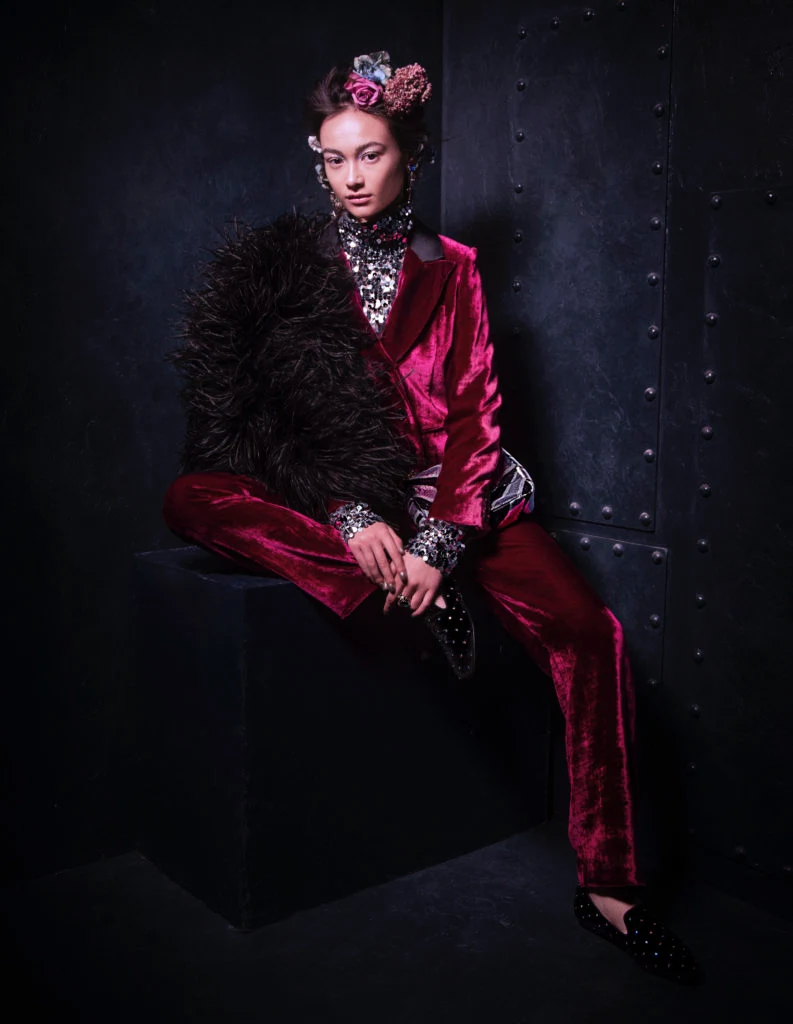 Pink velvet jacket, €450; pink velvet trousers, €320; both Masscob; sequin polo MM6 Maison Margiela, €380; all at Beautiful South. Earrings by Philippe Ferrandis, €115; ring by Thot Gioiello, €135; sequin bag by Tom Ford, €2,45; all at Brown Thomas, flat black velvet shoes by Kurt Geiger, €150 at Arnotts, black feather jacket by Paula Ka, €1,845 at Samui.