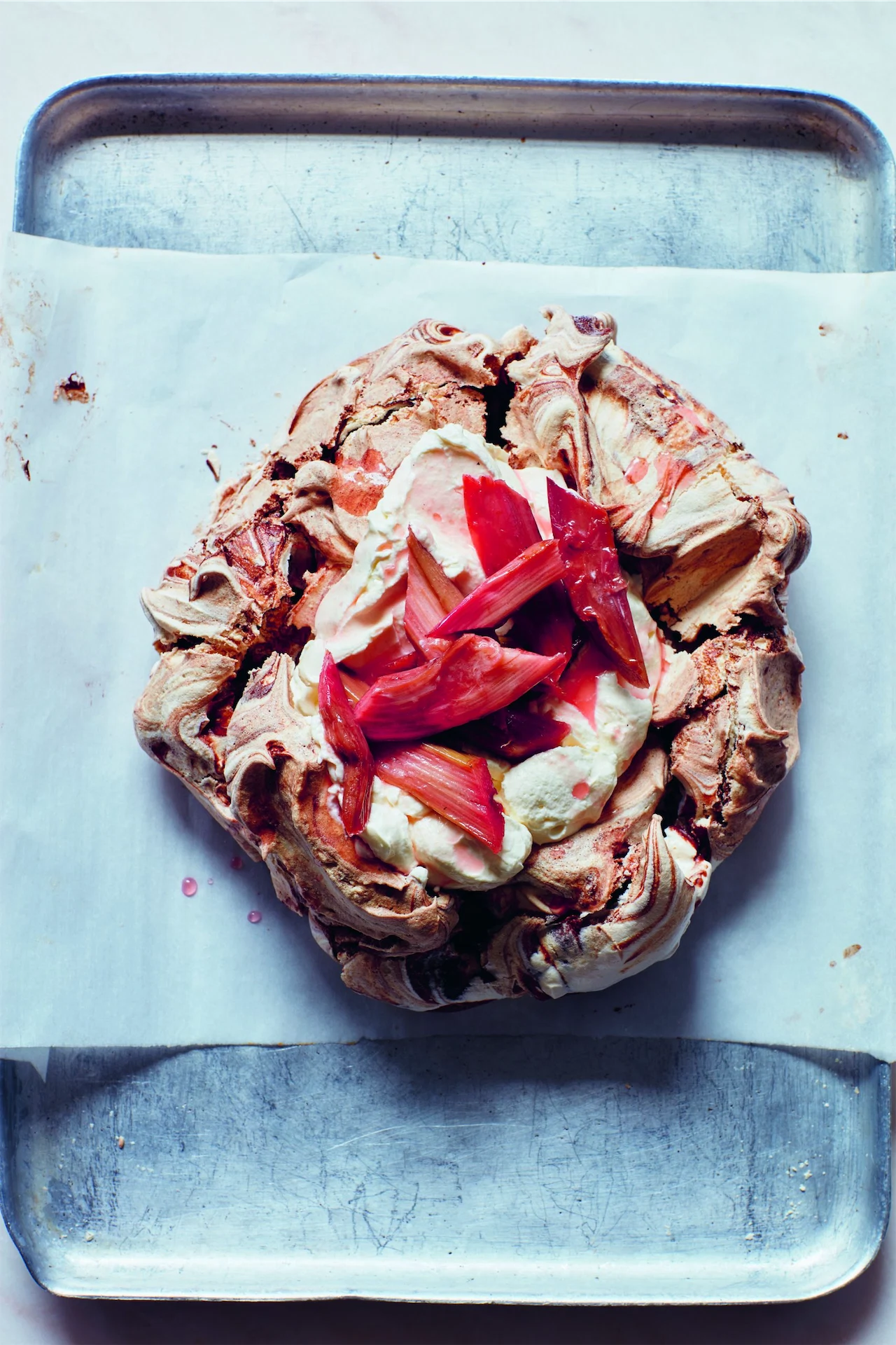 Chocolate-swirl pavlova with roasted rhubarb & cacao nib cream