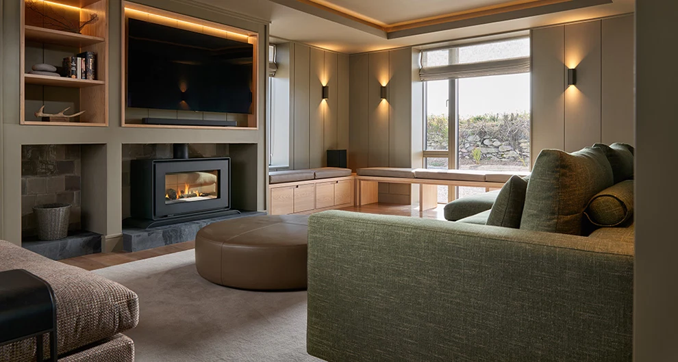 This country lodge in Co Kerry features a cosy family room with natural materials