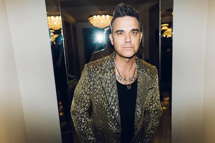 Robbie Williams says he was once targeted by a hitman at the height of his fame