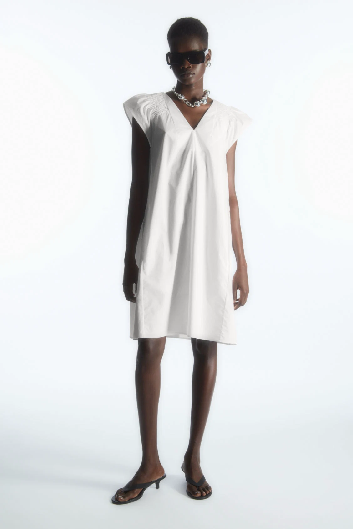 COS, Smocked V-Neck Mini Dress, €55