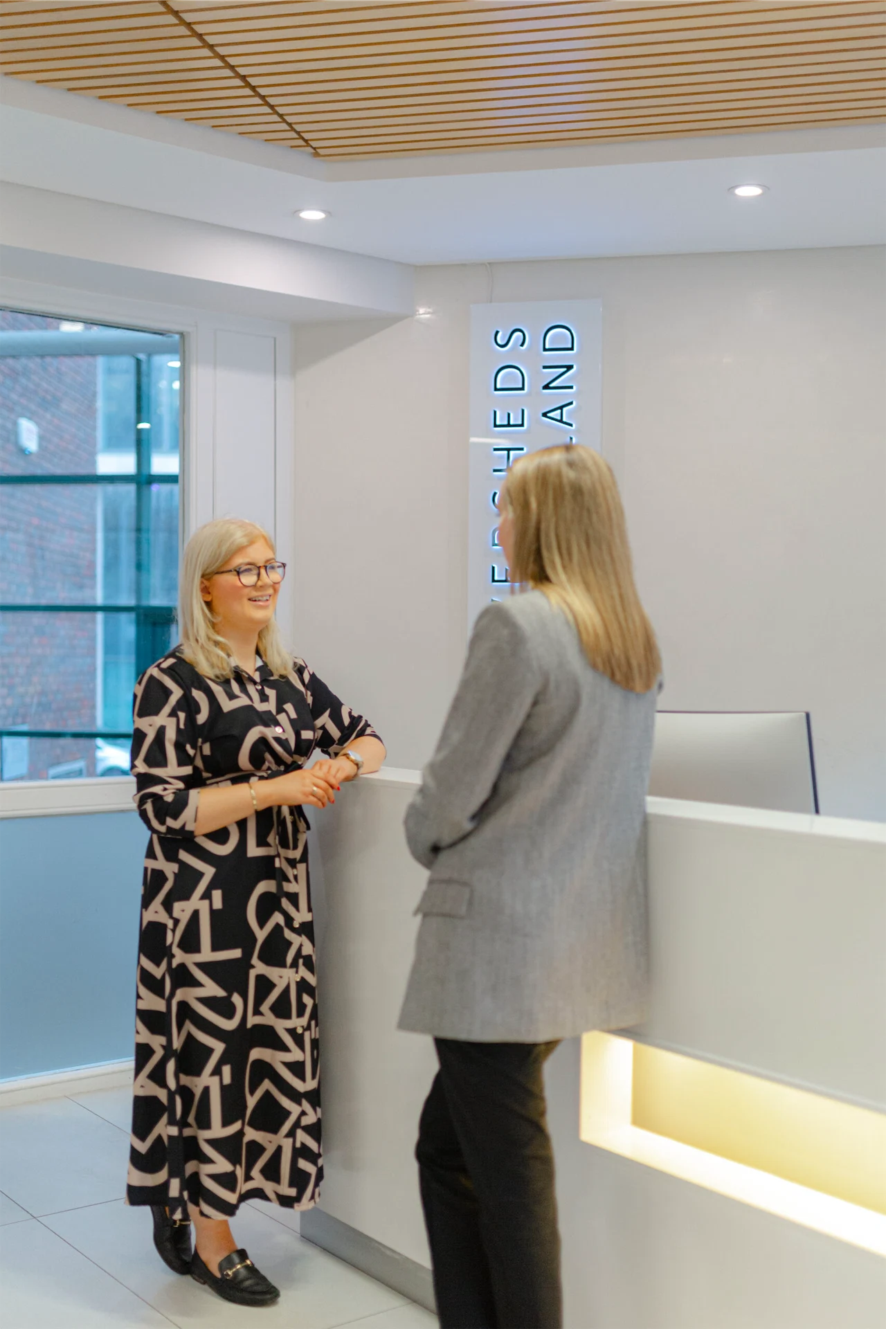 Niamh Donnelly talks to a co-worker at the Eversheds Sutherlands office.