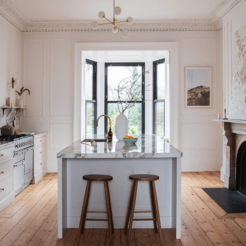 The kitchen units are by Rhatigan & Hick, and the bar stools are from Devol.