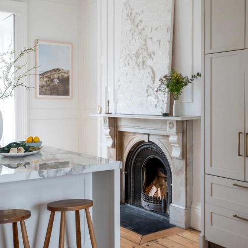 The artwork sitting on the mantelpiece is by Swedish artist Cream Imperial.