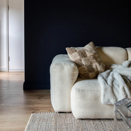 The basement level is painted in Inkwell by Colourtrend, and a Hay Mags sofa is the perfect place to curl up.