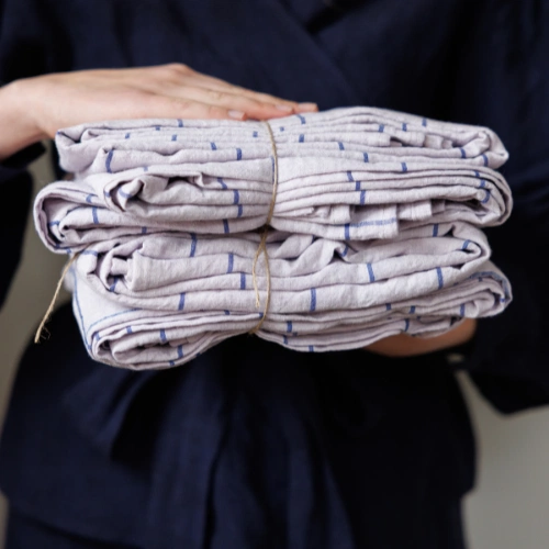 Neatly folded napkins tied up in twine.