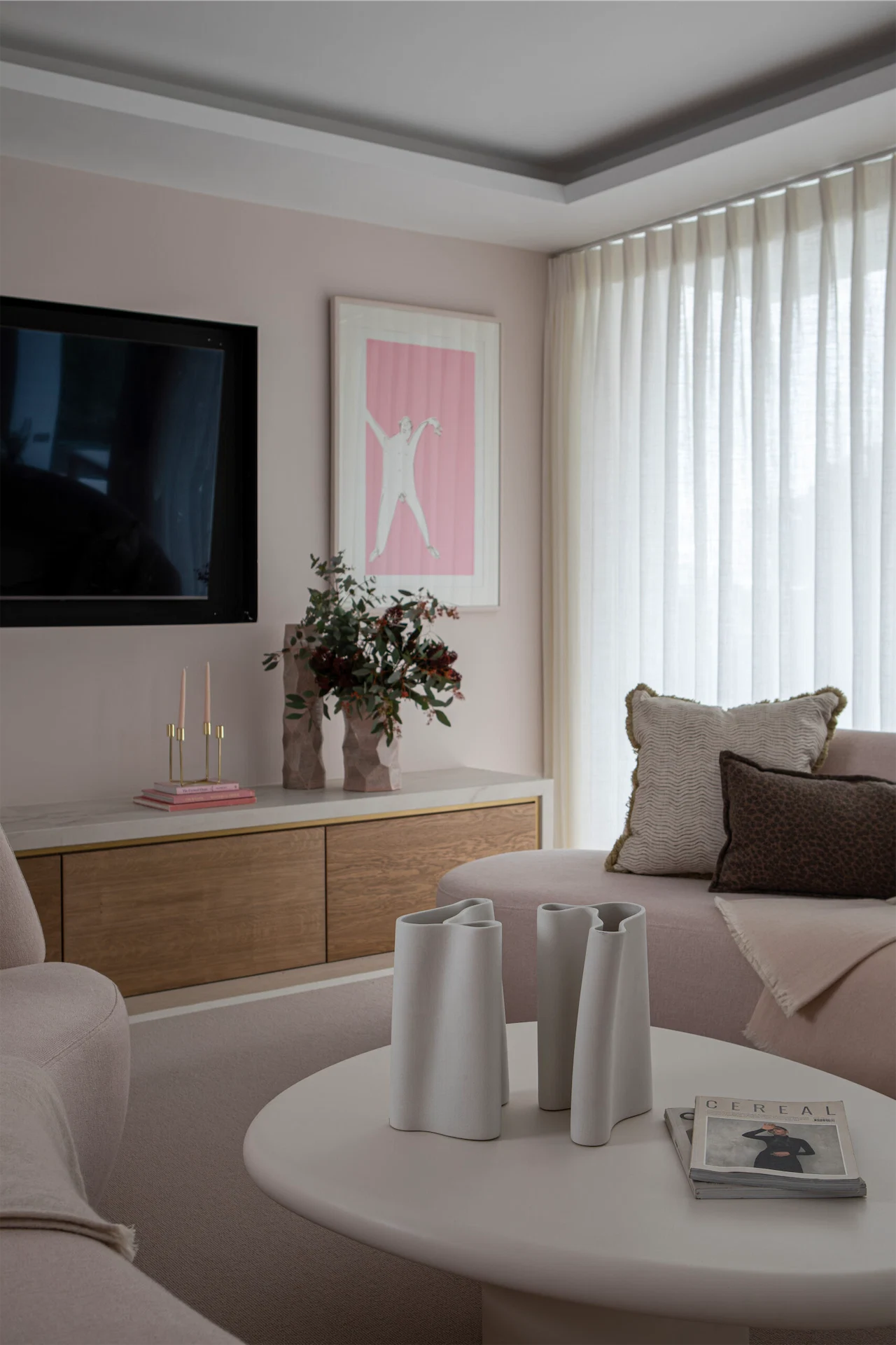 The pink sofas were bespoke made by Geri Designs, complemented by the soft pink of Powder Colour by Dulux Heritage on the walls. The vases are from Browsers.