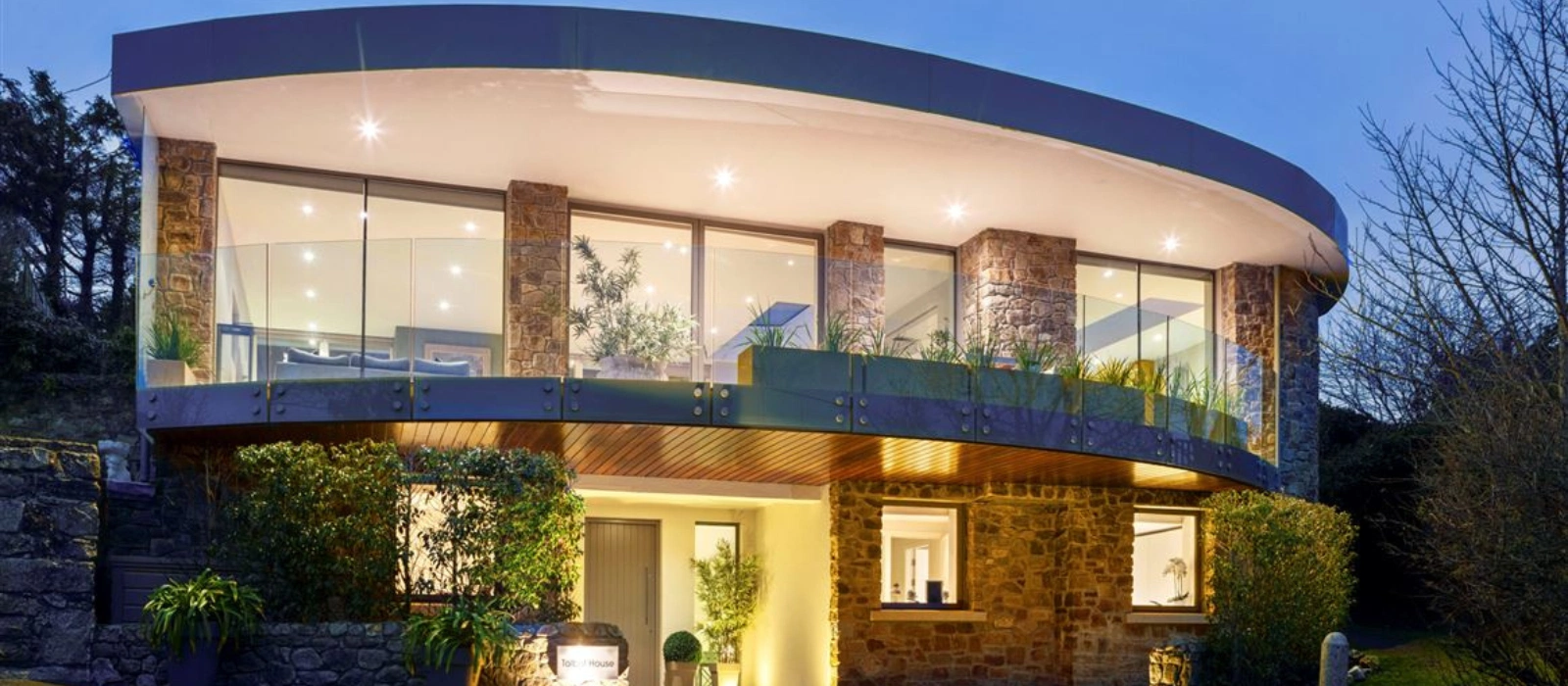 This home’s unique curved overhang balcony boasts stunning views across Killiney Bay