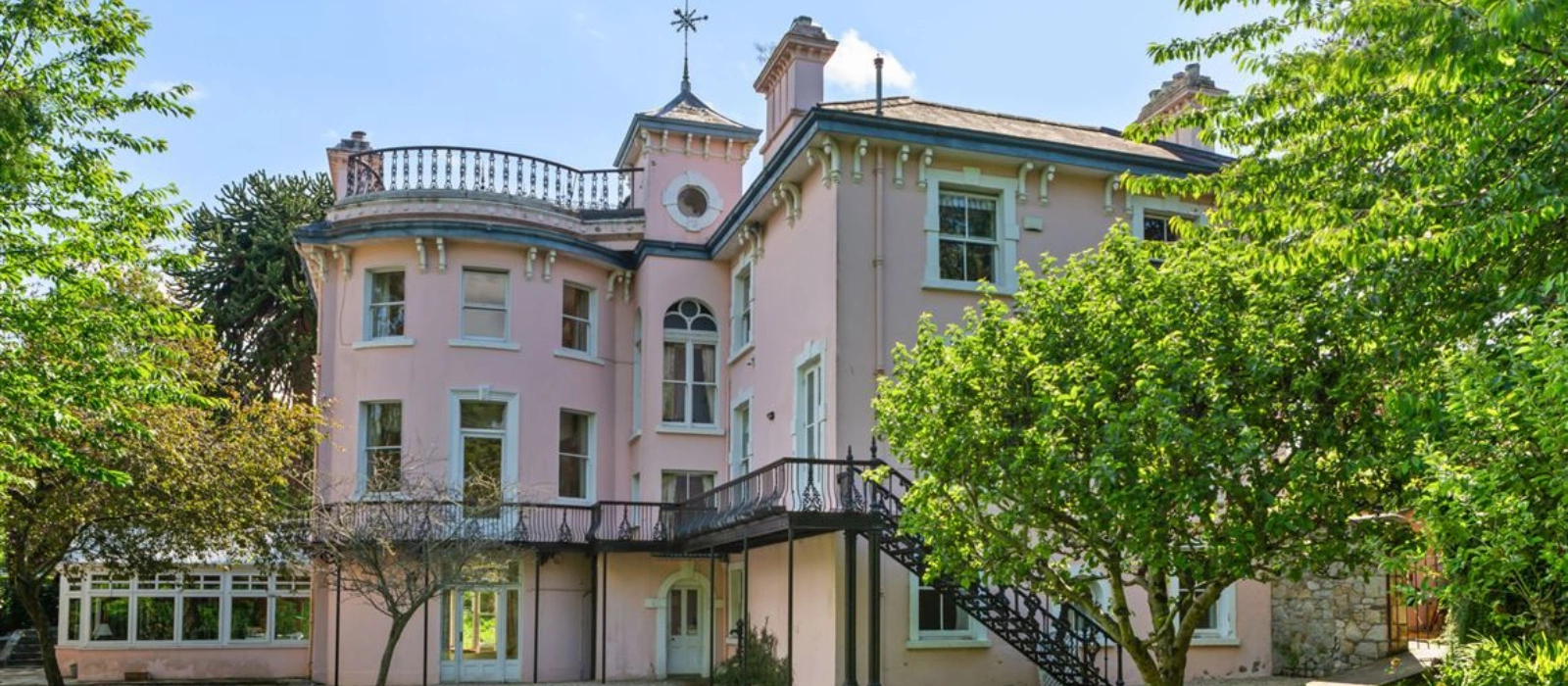 This powder pink Blackrock home has an extensive library and beautiful cast iron balcony This powder pink Blackrock home has an extensive library and beautiful cast iron balcony