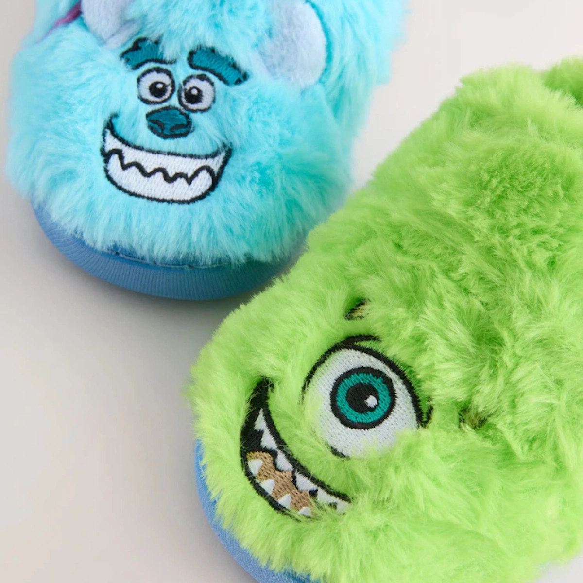 Next Blue/Green Monsters Inc Fluffy Cupsole Slippers, €16.50-€18.50