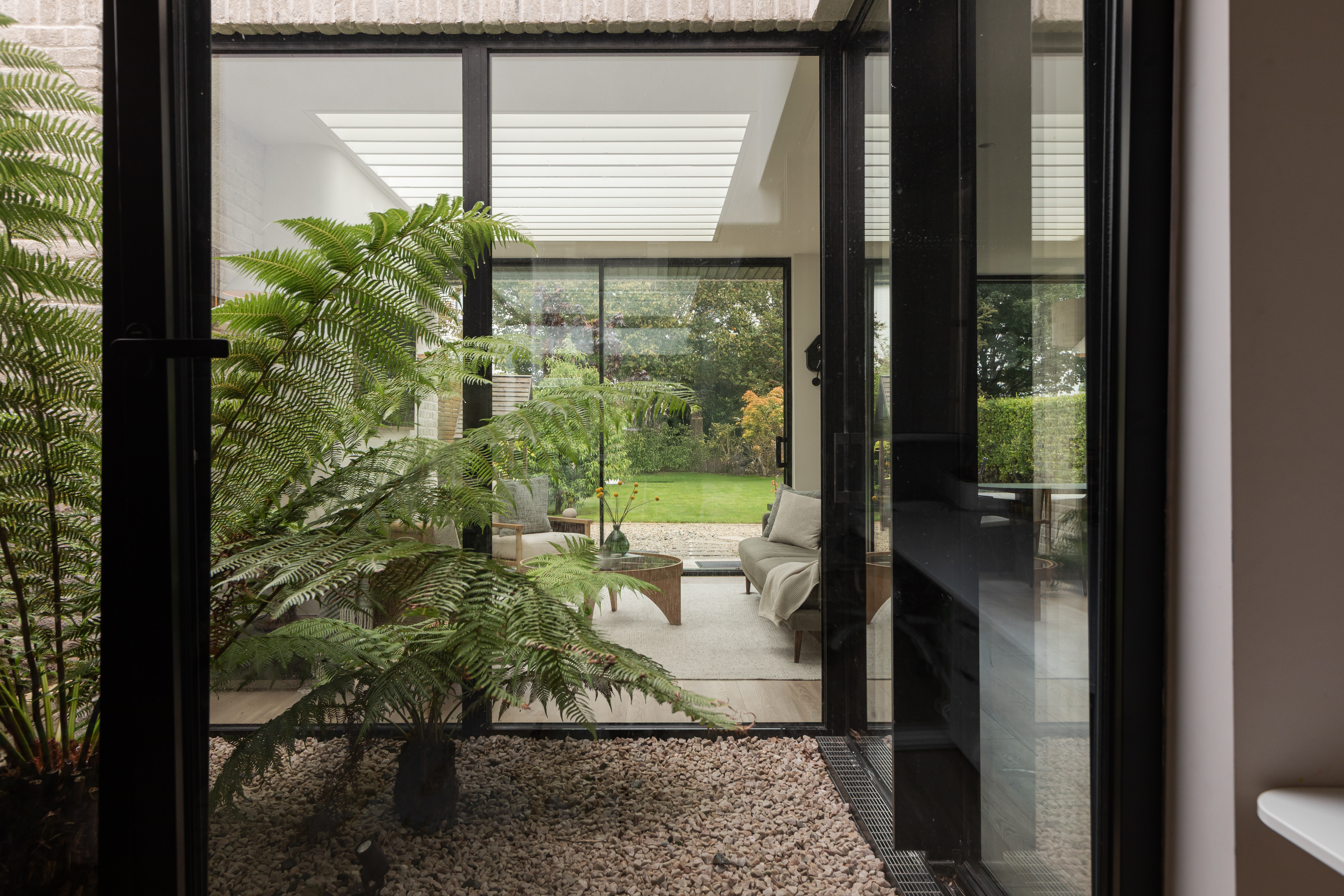 An internal courtyard and generous glazing flood this Dollymount home with natural light