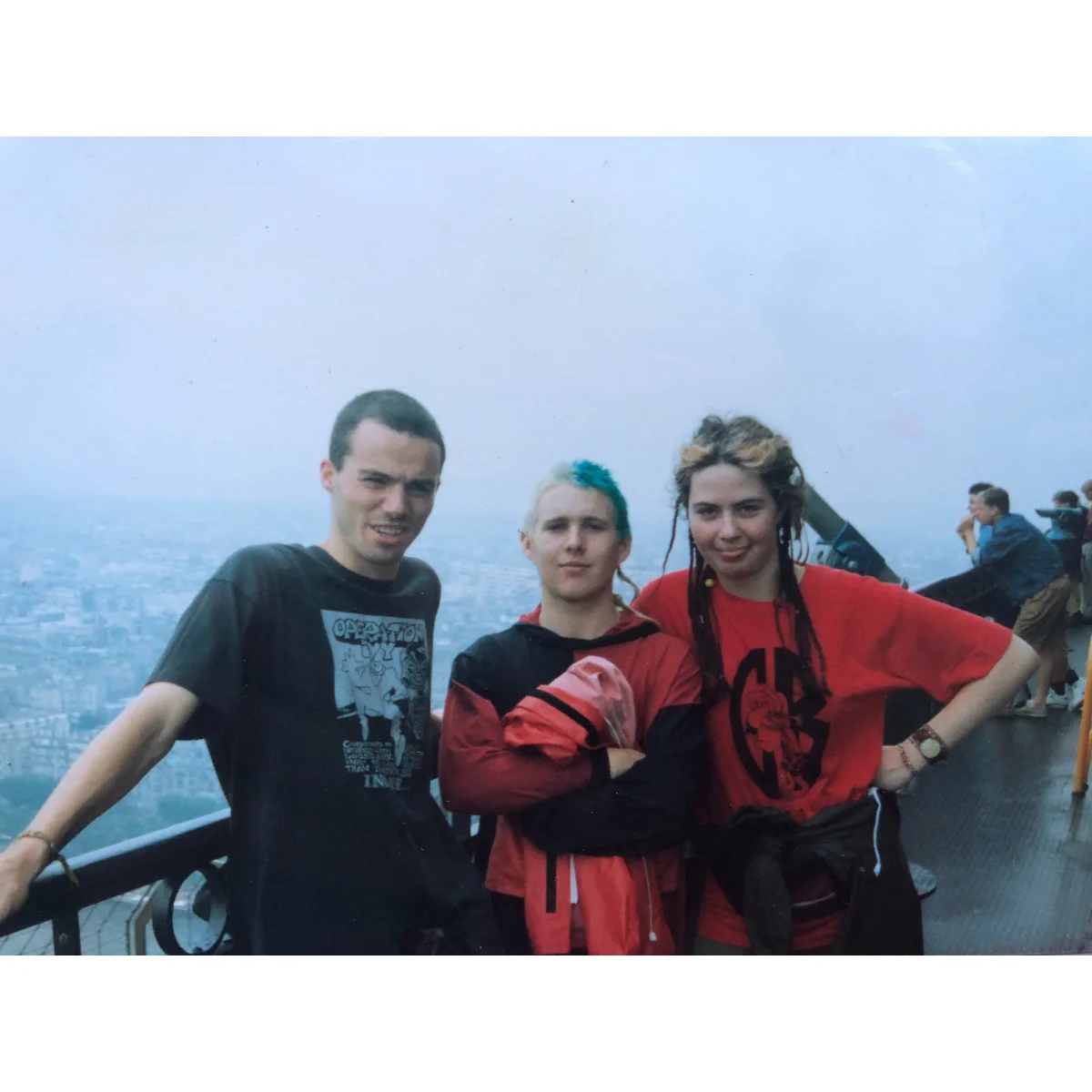Edel McGinley (right) wearing her homemade Guerilla Biscuits t-shirts (In Memorium) at the top of the Eiffel Tower late 1980s).