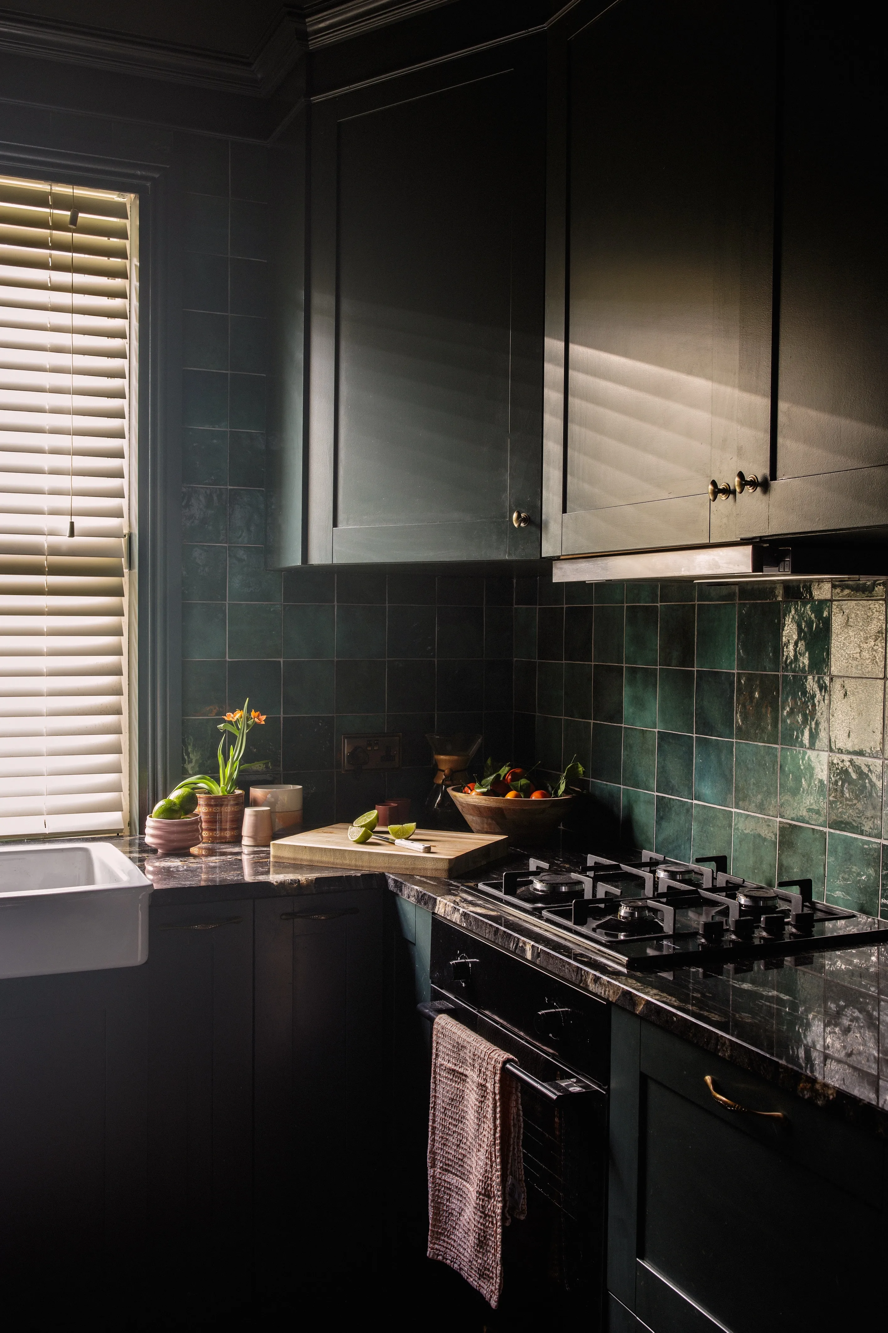 Farrow & Ball Studio Green in this moody kitchen. Photo: Al Higgins
